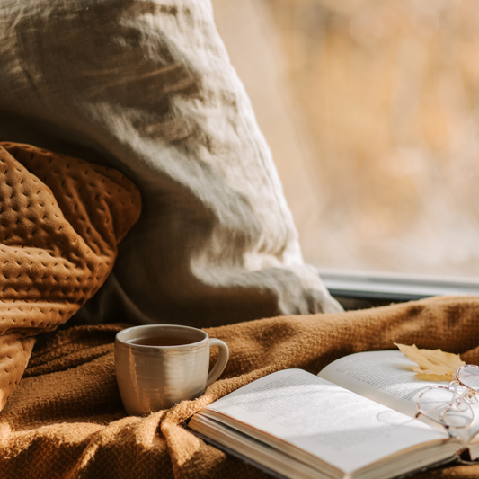 Cozy Autumn Nook with Book, Tea, and Blankets